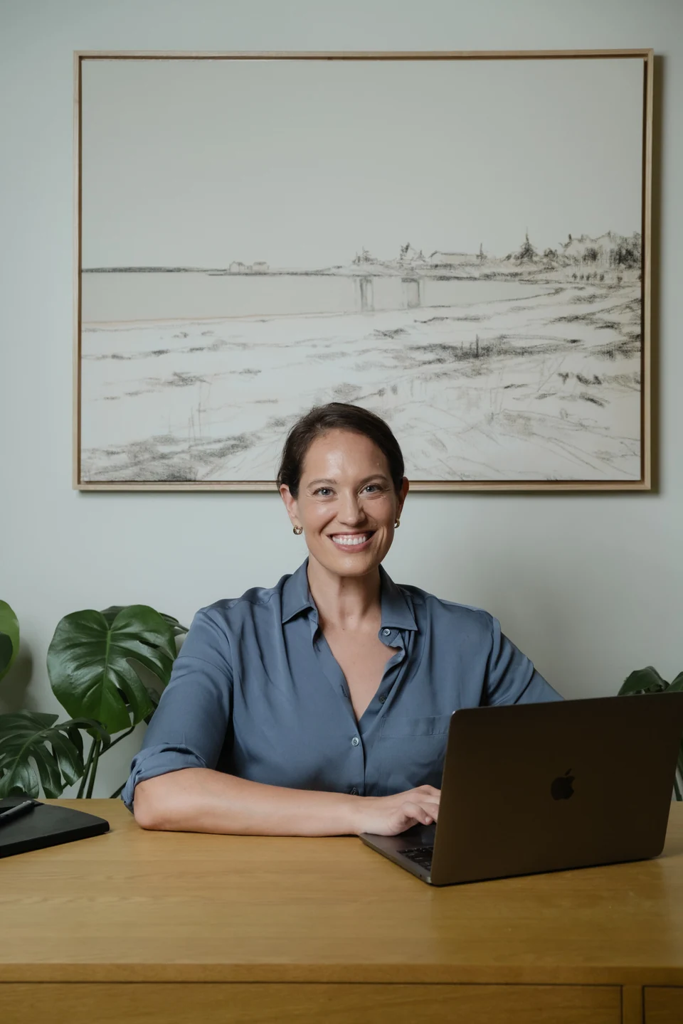 Annie Wright at her desk with her laptop.