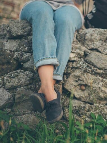 Image of woman's ligs as she sits on rocks. This post is about: Here's why what you've likely learned about feelings is dead wrong.