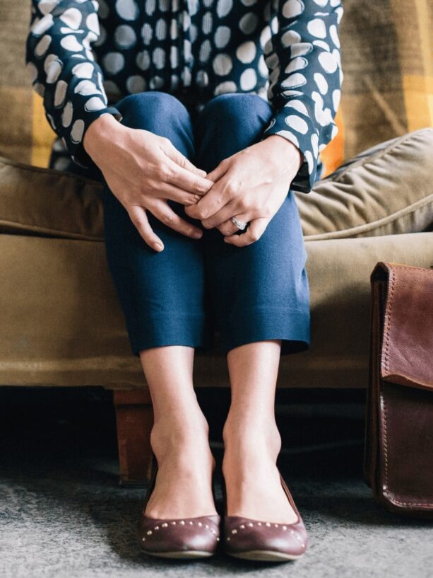 Image of woman from the waist down grasping legs. This post is about therapy tips