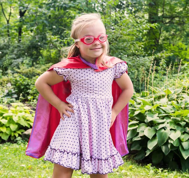 How can childhood trauma adaptations be superpowers? Image of child in a cape and mask.
