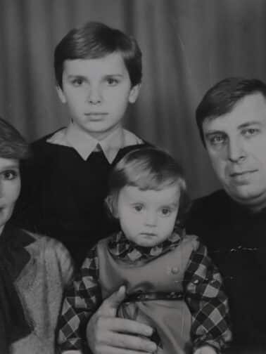 Old family photo which pictures, mom, dad, brother, and little sister representing relational trauma experiences that go beyond caregivers