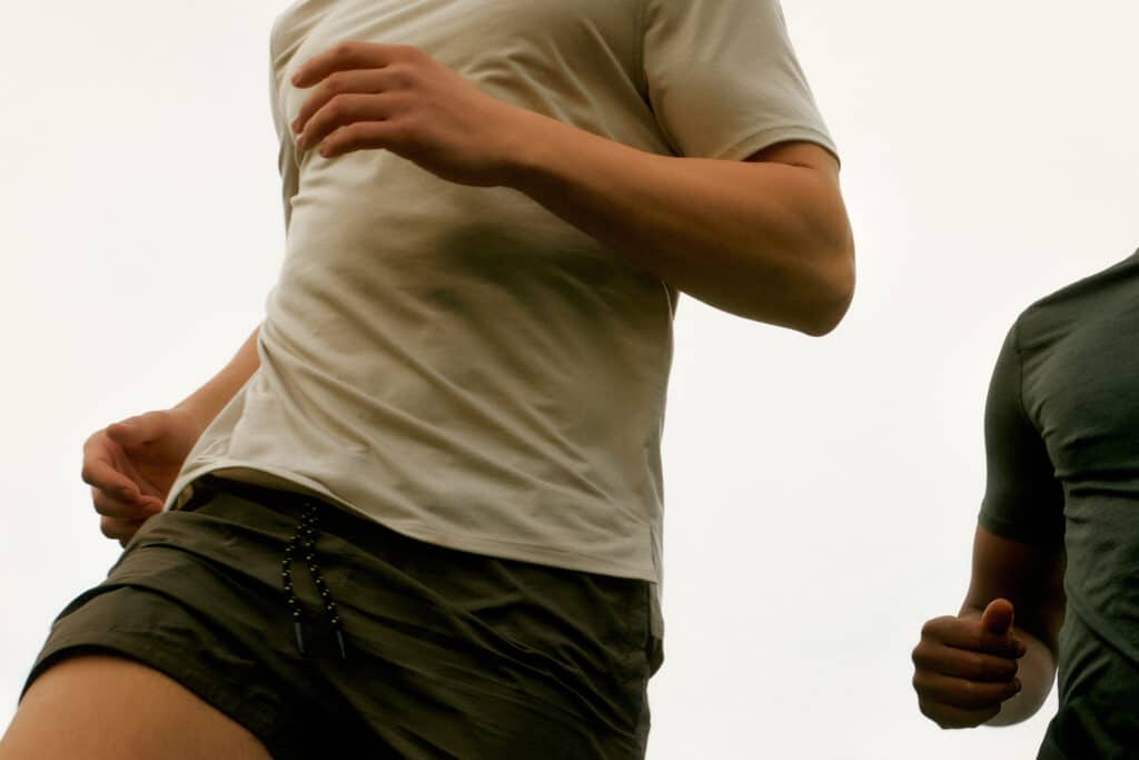 Two people running side by side, symbolizing the push-and-pull dynamic often present in trauma bonding.