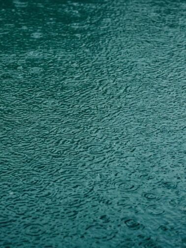 Abstract rain on teal surface