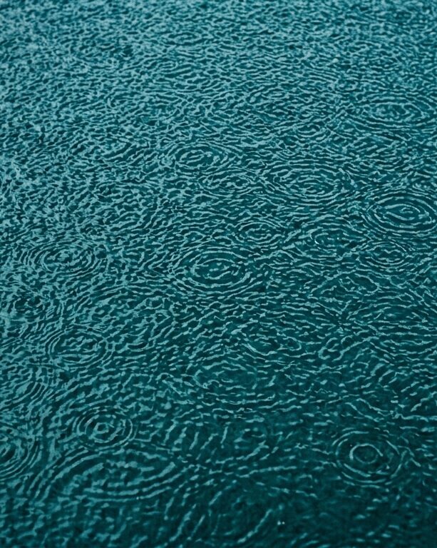 Abstract rain on teal surface