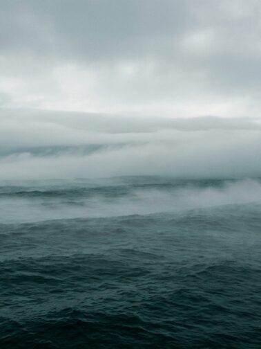 Fog over dark teal ocean
