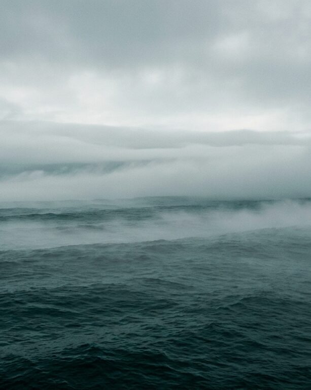 Fog over dark teal ocean