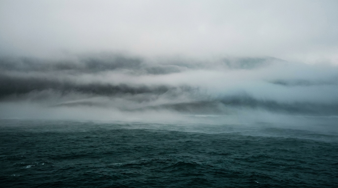 Fog over dark teal ocean