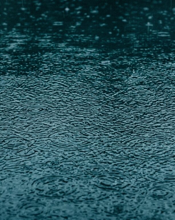Rain falling on water surface