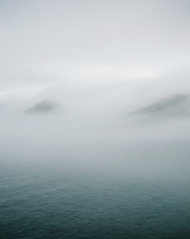 Sea fog lifting over calm water — representing the journey of healing from complex PTSD