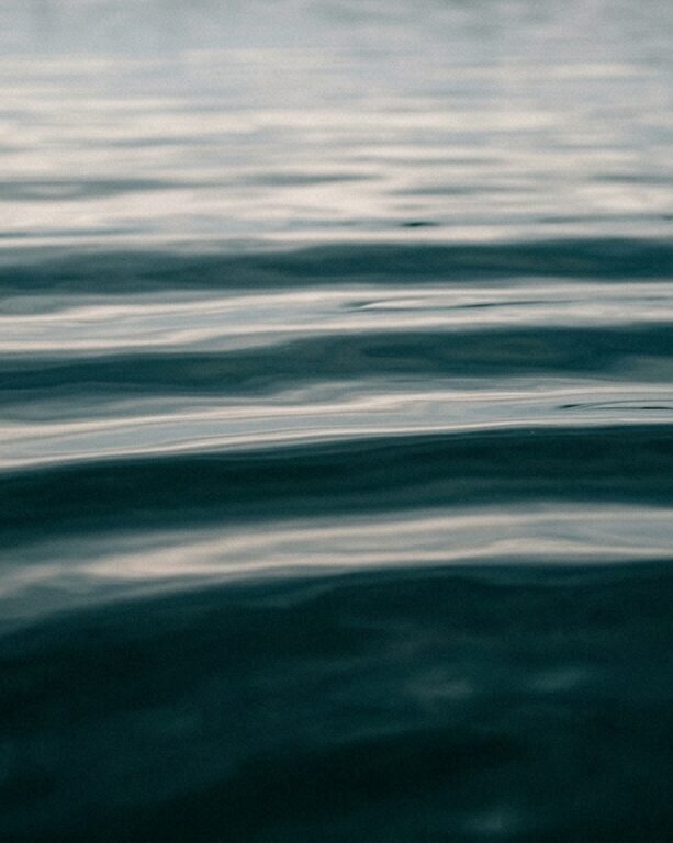 Pale grey sky reflected in still water