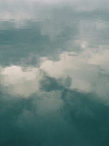 Calm ocean waters meeting an overcast sky at the horizon