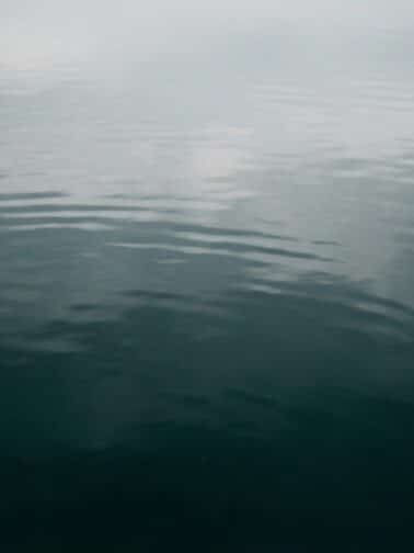 Moody seascape with clouds reflected in still waters